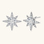 Sterling silver star-shaped stud earrings with brilliant moissanite center stones and pavé details on neutral background.