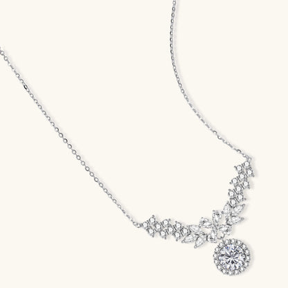 Elegant sterling silver necklace featuring intricate wing-like design with brilliant moissanite stones on neutral background.
