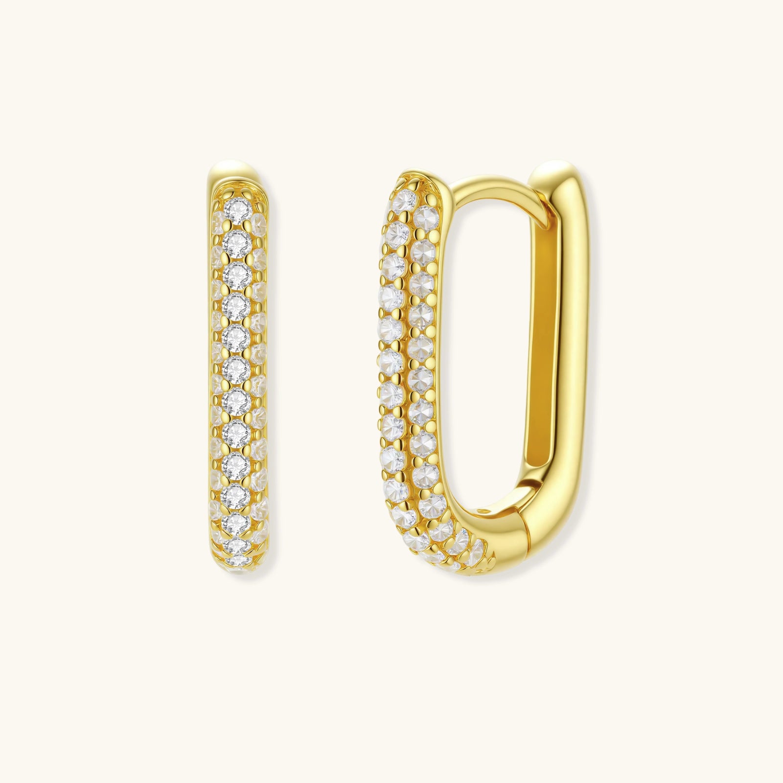 Close-up of small sterling silver huggie hoops completely covered in sparkling clear crystals with hinged closure