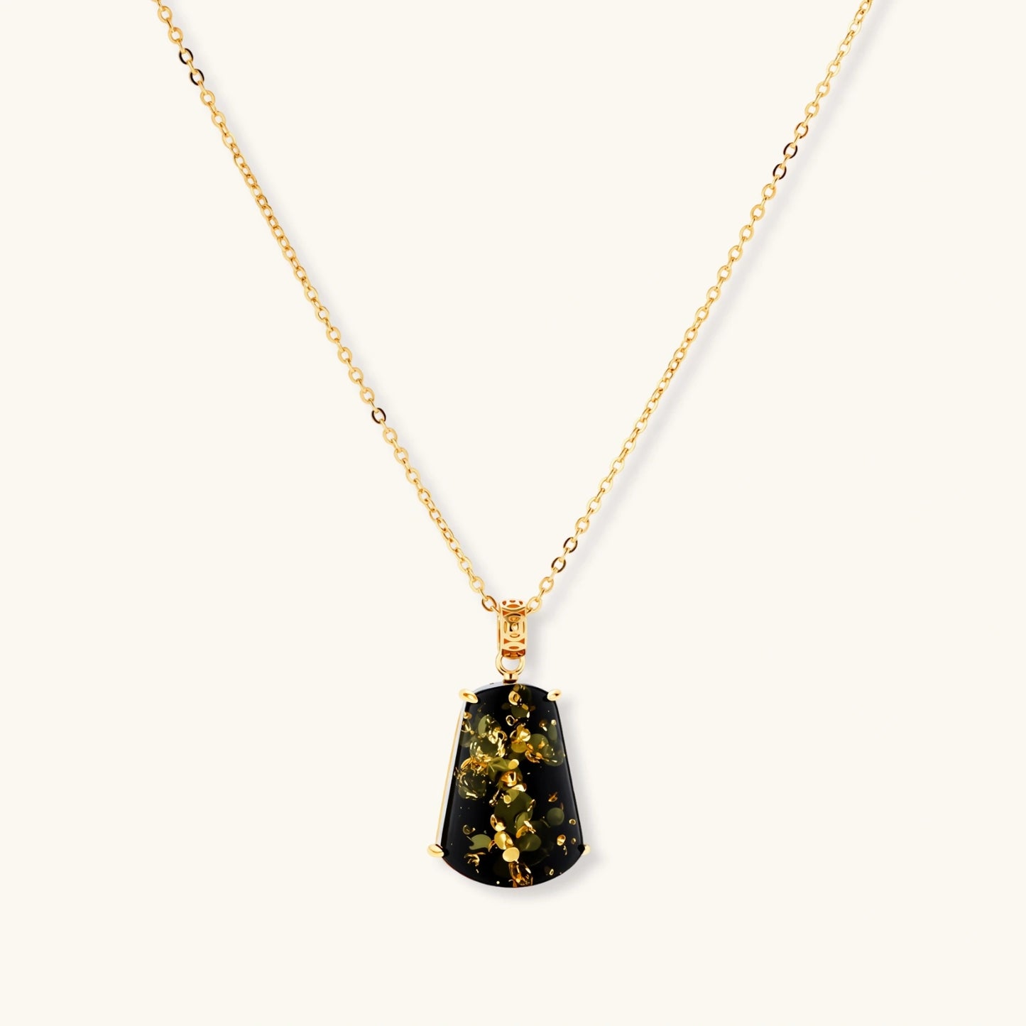 18k gold-plated necklace and earrings with green amber pendants featuring golden inclusions on cream background