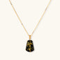 18k gold-plated necklace and earrings with green amber pendants featuring golden inclusions on cream background