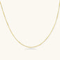 Delicate gold-plated sterling silver chain necklace with geometric segments displayed against cream background