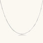 Delicate platinum-plated sterling silver necklace with alternating textured cubic links and smooth chain sections.