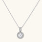 Platinum-plated sterling silver necklace with round halo pendant featuring central crystal surrounded by smaller stones