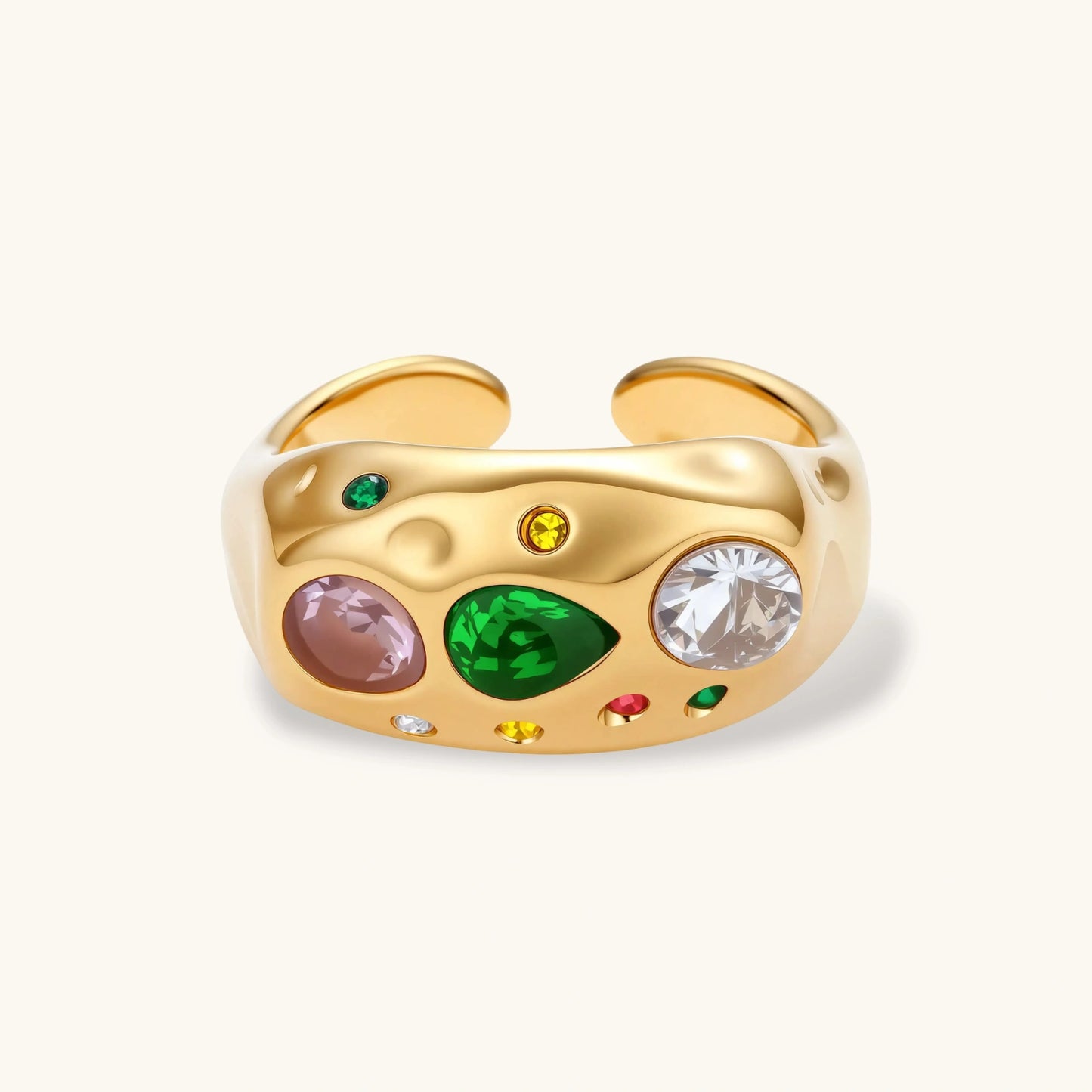 Gold-plated adjustable dome ring with pink, green, white, red, and yellow cubic zirconia stones on cream background.